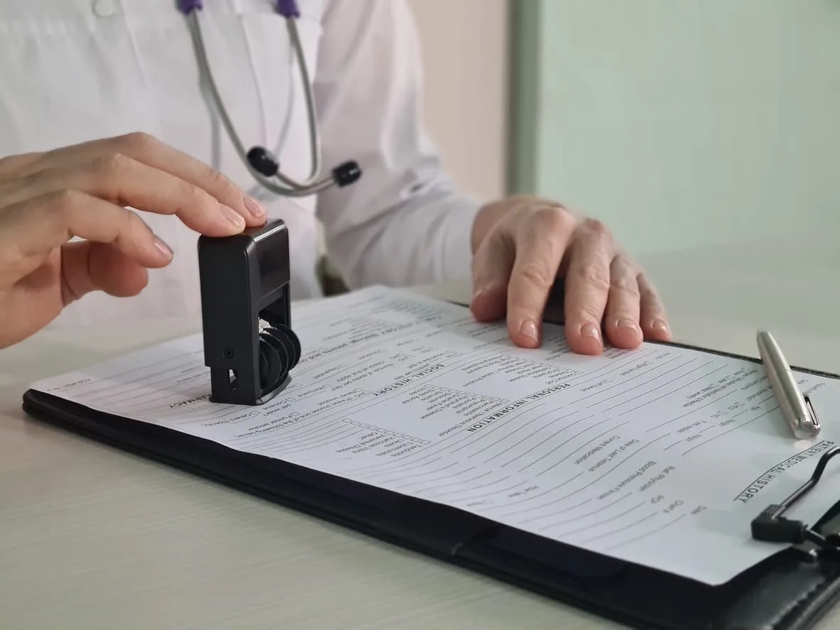 Doctor stamping a medical report – essential for immigration, visa applications, and international use. Learn how to get your medical report notarized with NotaryPublic24.