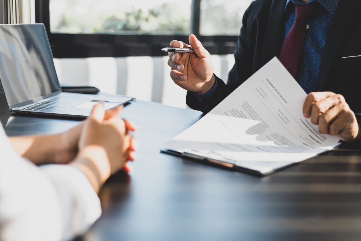 Business meeting reviewing official Companies House document for online certification and Apostille – fast and secure UK document verification process