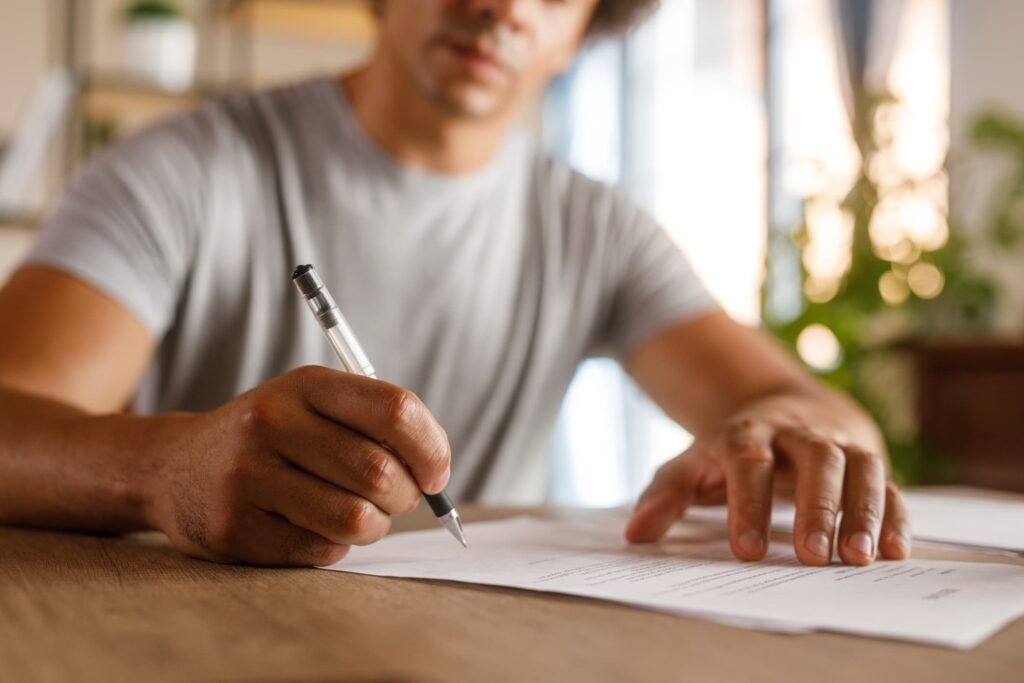 Parent signing educational power of attorney form to authorize school decisions – legal document notarization and Apostille service by NotaryPublic24.