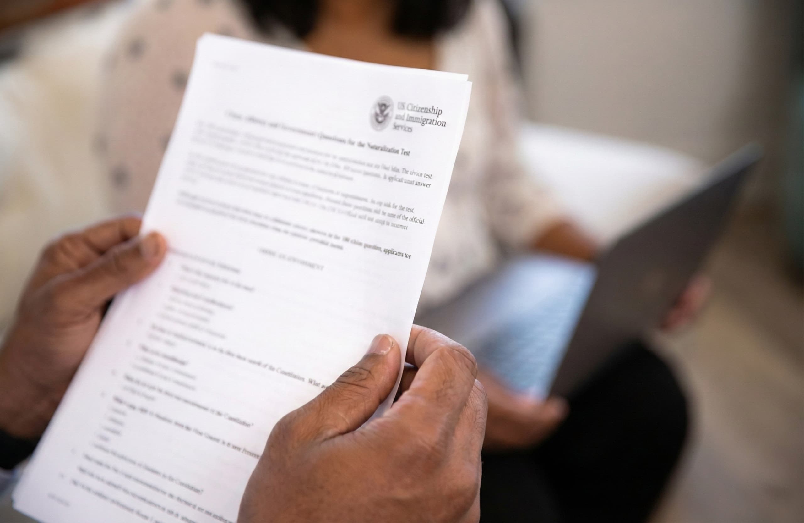 Person reviewing immigration documents for notarization before submitting forms for immigration application and online notary verification at NotaryPublic24