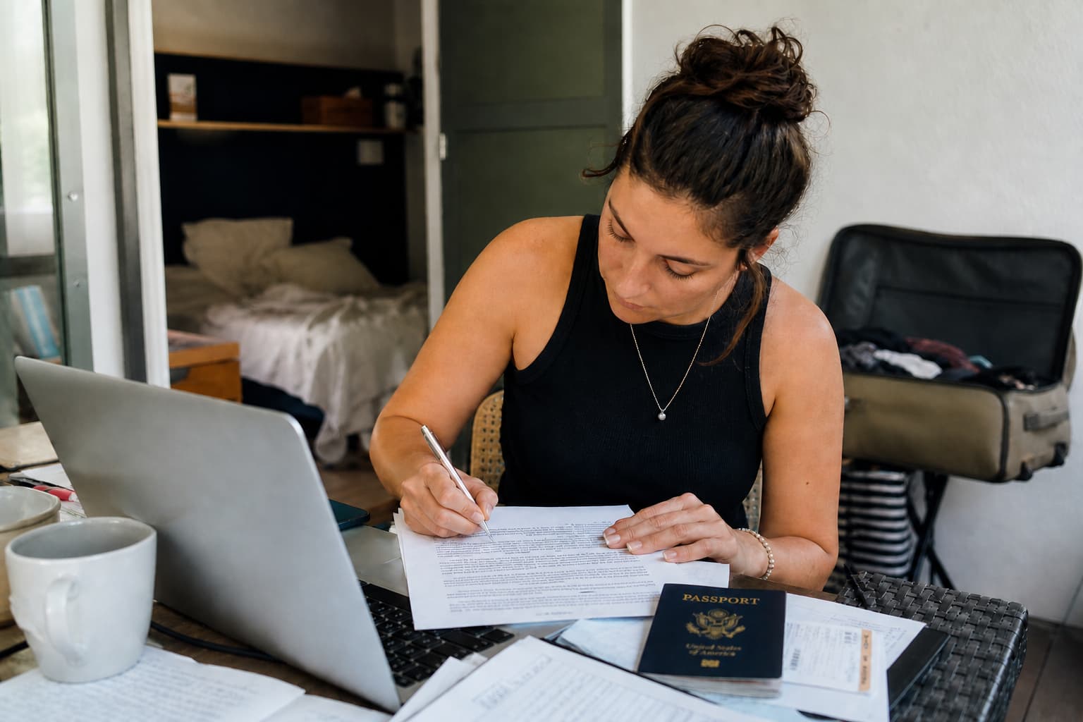 Här är en mer keyword-rik alt text med titel + varumärke inkluderat: **Alt text:** Notarize Power of Attorney from Abroad guide by NotaryPublic24 – woman signing power of attorney document with passport and legal paperwork while living abroad