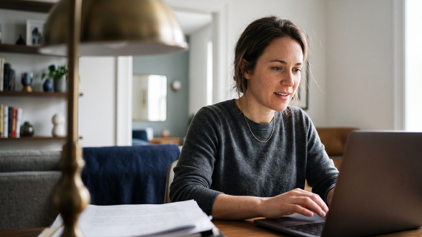 Executor reviewing estate paperwork and a brokerage statement at a desk to settle a deceased relative's securities – NotaryPublic24 guide to the affidavit of domicile, notarization and Apostille