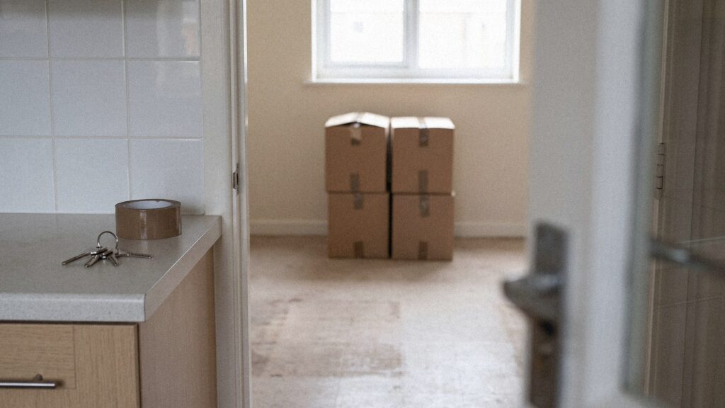 Power of Attorney to Sell Property: How It Works 5 Power of attorney to sell property – moving boxes and keys in a half-cleared flat, notarized online with NotaryPublic24